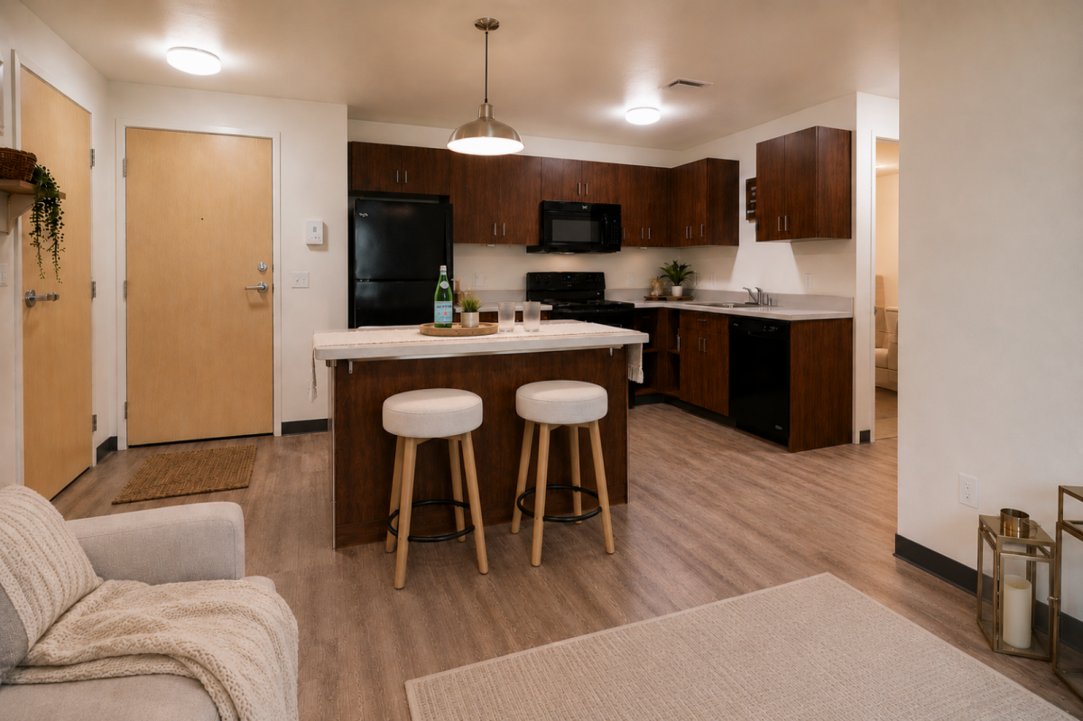 Rendering of an apartment kitchen with dark wood cabinets, black appliances, island seating, and entry door.